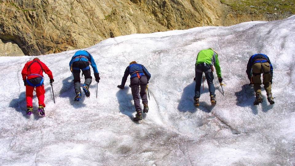 group of  friends using climbing crampons