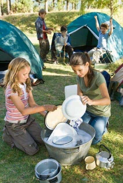 Kids doing dishes at campsite