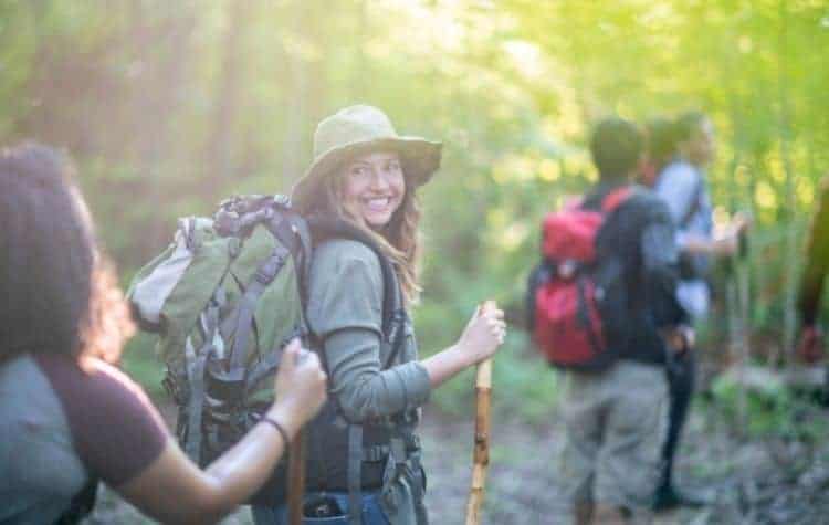It's important to wear a sun hat while hiking in shaded forest