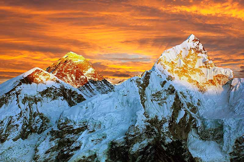 A horizontal image of sunrise over the himalayas.