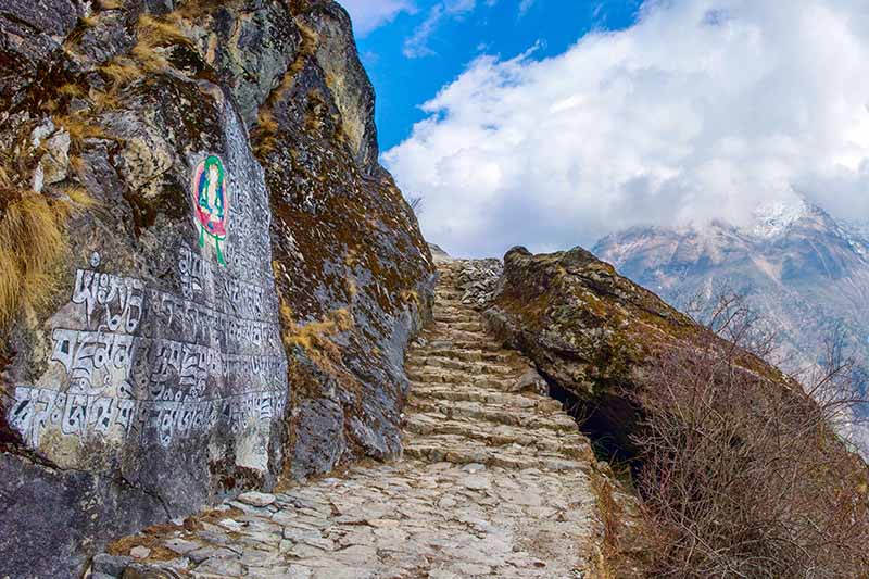 A horizontal image of a track on the side of a mountain in the Himalayas.