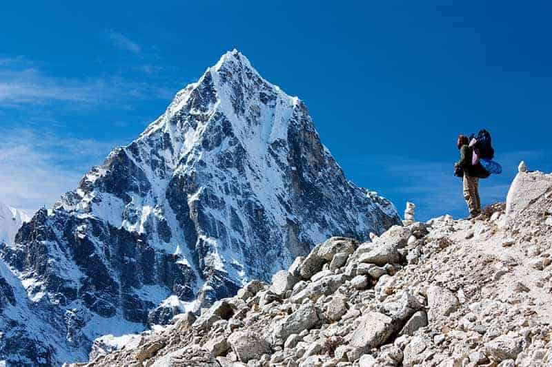A horizontal image of Mt Pumori pictured on a blue sky background.
