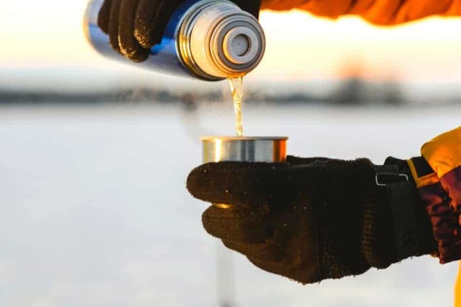 Camp coffee with hiking gloves