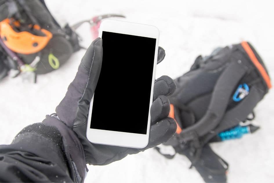 winter gloves holding phone