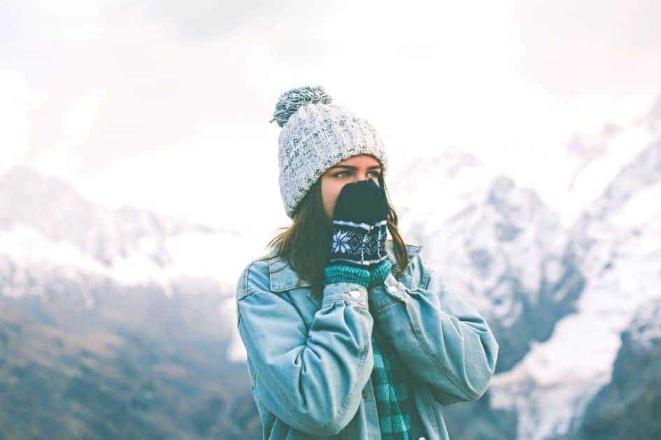 Hiker using mittens to keep her hands warm