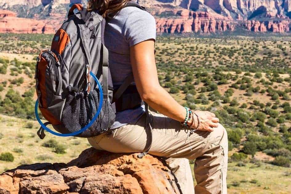 female hiker wears tan hiking pants