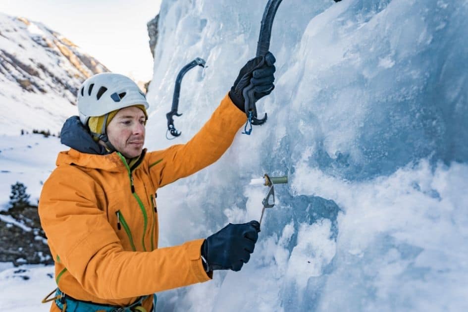 Ice Climber ;using anchors, ice axe adze and ice axe hammer