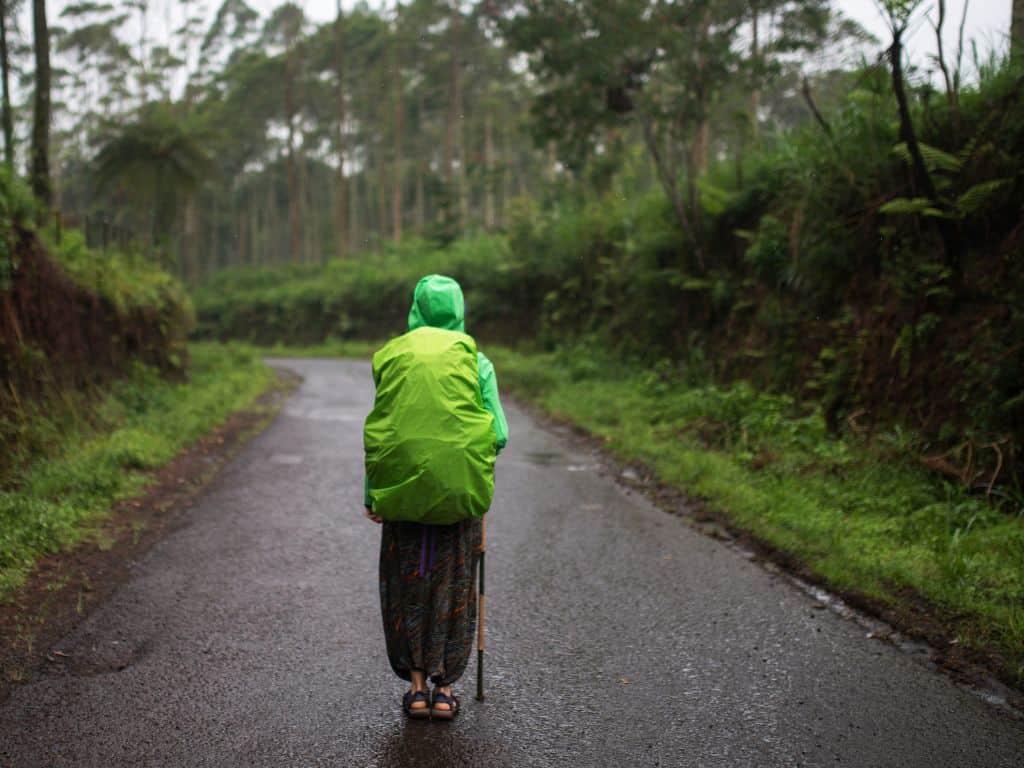 backpacker wears rain jacket