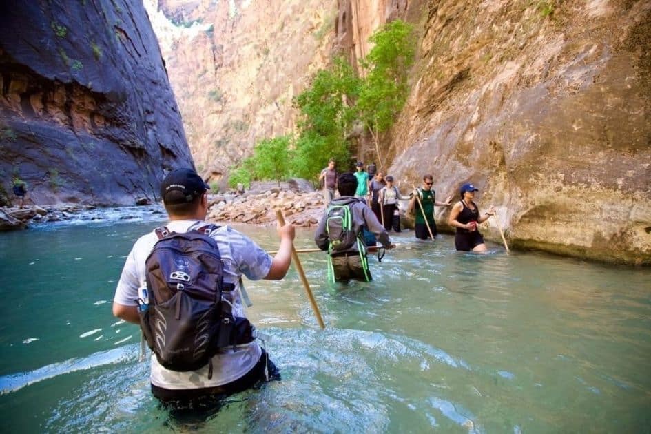 Hikers traversing lake