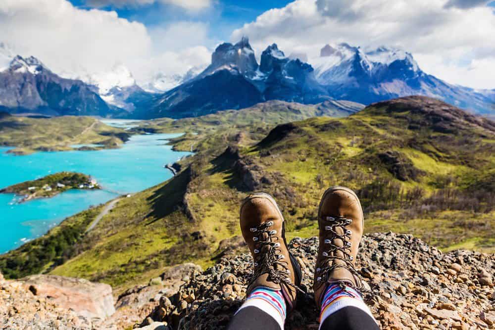 man sitting with hiking boots on