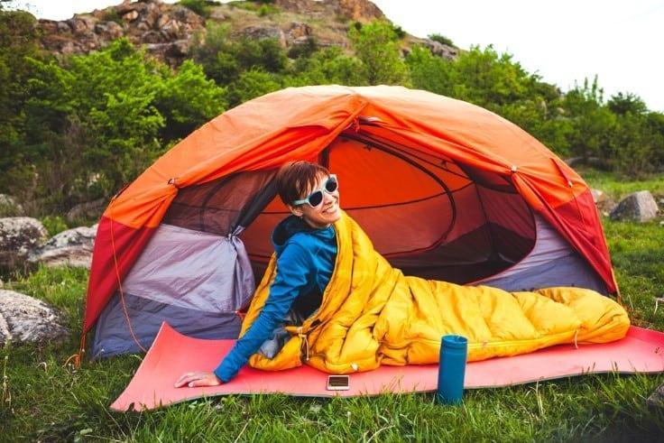 women waking up in sleeping bag